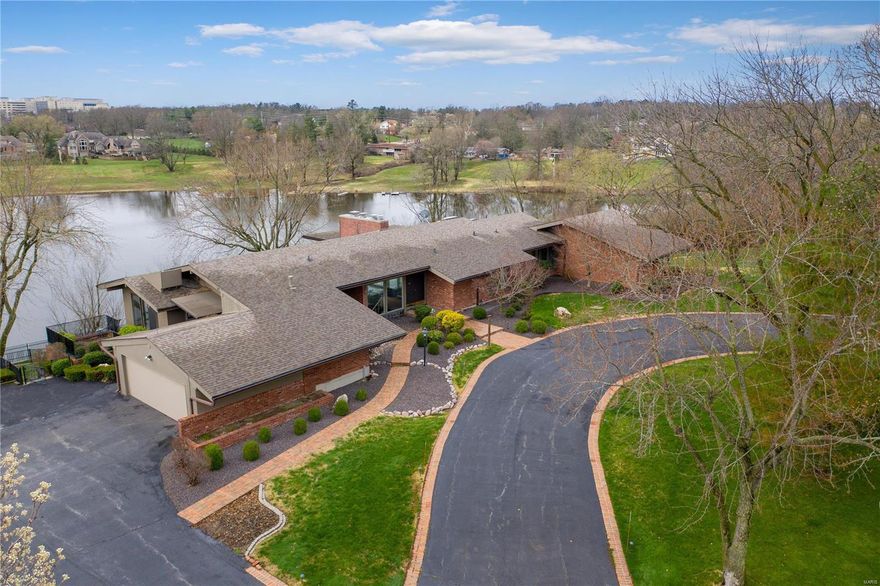 Price reflects as is sale and need for improvements. Sensational mid-century home with captivating lakefront lot. Priced near lot value alone!  Over one-acre lot! The setting of this California soft contemporary one-level home is superior to most waterfront homes at Lake of the Ozarks. Stupendous views from nearly every space. Floor plan is very much like an atrium ranch. Owner's suite has private screened porch perched above lake. Lower level is full daylight and walk out. Large level area overlooking lake. Substantial, newer retaining wall. Private dock.  Home, lot, and dock all sold AS IS. Circular drive allows you to pull up to the front door. Enter an amazing glass enhanced residence with enormous living/dining room with vaulted ceilings and magnificent view. Cozy galley kitchen with transom windows leads to side entry garage and sun filled breakfast room with private patio. Spacious bedrooms and an enormous owner suite with fireplace and ample closet space. Finished lower level.