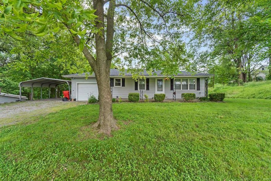 Country living in this Kelso home with NEW updates. Home, situated on a shady lot, has covered porch running width of the home.  Main level (all but bathroom) has NEW attractive vinyl plank flooring and fresh paint job. Spacious main level living room has five windows providing a nice view and bright space. A curved entryway leads to the eat-in kitchen with an abundance of cabinets and a large pantry. All appliances are included.  There are two nice size main level bedrooms.  The full bathroom has a tub/shower combination and an updated vanity.  Downstairs is a spacious family room, storage, laundry, and a half bath.  A covered patio is on the rear of the home, perfect place to park your bbq grill.  The roof is 2-3 years old.  HVAC, Windows, Water Heater all new within 8 years.  The vinyl sided home has an attached one car garage and a two-car carport cover.  The backyard large utility shed is included.  This home is in the Kelso School District and has easy access to I-55.