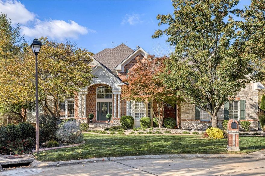 Outstanding brick & stone 1.5 Sty in premier neighborhood! Beautifully designed & stylishly appointed to accommodate daily comfort & gracious entertaining. 2-Sty marble foyer highlighted by dramatic curved staircase leads to study with built-in bookcases, elegant dining room and stunning great room with brick fireplace & soaring windows with private wooded views. Designer kitchen featuring 42” white cabinetry, quartz countertops & KitchenAid appliances adjoins sunlit breakfast room & vaulted hearth room with custom built-ins. Coffered master bedroom suite with 2 walk-in closets & luxury bath with jetted tub opens to private deck with hot tub. Front & rear staircases access 3 additional bedrooms, bonus room & 2 full baths. Walk-out Lower Level includes recreation room with fireplace & entertainment center, billiard room, gathering bar, workout room & full bath. Situated on a .5 acre cul-de-sac lot with 3 decks, patio with fire pit & 3-car garage. Katy Trail is just steps away.