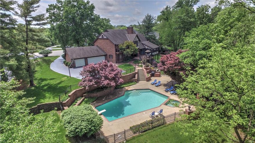 Updated custom built 1.5 story home on private cul-de-sac on AN INCREDIBLE 1.92 ACRE LOT with a Pebbletec white pearl finish pool. Entry is flanked by a formal dining rm w/bay window & living rm w/wood flooring; ML w/large bedroom w/en-suite bath, office w/built-in shelving & 9' ceilings on ML. 2 story Great rm offers vaulted ceilings, wall of windows overlooking the wooded lot, see-thru flr-to-ceiling travertine fireplace to the kitchen & a wet bar. The kitchen/breakfast rm/hearth rm is truly the heart of the home flaunting granite counters, sub-zero fridge, butler's pantry w/wine cooler, new cooktop, hardwood & large center isle. Rear staircase takes you upstairs to 3 generously-sized bdrms w/walk-in closets. Master suite boasts hardwood, crown molding, private balcony & luxurious bath w/dual granite vanities, shower w/multiple sprays & bench seat, separate air jet tub & custom walk-in closet. Outside you will find a maintenance free composite deck, screened-in porch & 3-car garage. Additional Rooms: Mud Room