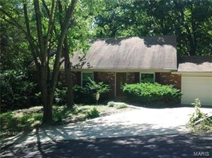 Come Take a Look!! Enjoy lake living in this 1 1/2 story home with 4 bedrooms 3 baths, kitchen features custom cabinets, solid surface counter tops, stainless appliances, hardwood floors in living room, dining room, and kitchen.  Bathrooms all have ceramic tile floors, Master bedroom is on main level, 4th bedroom and bonus room in upper level,  entertain your family and guest in huge family/game room with fireplace in basement, also there's plenty of space with a shop/hobby/craft room in lower level.  Full walk-out basement, huge oversized 2 car attached garage, with lots of storage and plenty of room for a boat & water toys.  Enjoy wildlife and privacy deck overlooking nice wooded lot.   A lot of house for a large family.   Lake Sherwood living at its best!