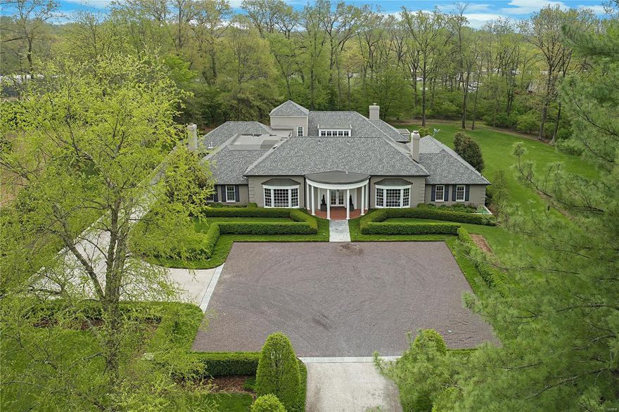 Welcome to this one-of-a-kind architectural masterpiece residing on almost two acres of beautifully landscaped grounds. An elegant, tree lined, gravel drive leads you to an inviting motor court.  Upon entry you will delighted by the stunning design & thoughtful upgrades. The garden courtyard, the heart of the home, brings the outdoors in with every view.  Entertaining is a breeze with the large dining room, sunlit living room, & handsome media room featuring a wine cellar.  The chefs kitchen opens to vaulted breakfast  hearth rooms with built in desks.  Additionally the main floor features a vast primary suite with a spa-like bath & spacious walk-in closets along with an additional en suite bedroom. Separate staircases lead upstairs to three generous bedrooms, two full baths, & a large second family room. An attached three-car garage, mudroom, basement recreation room, & two laundry rooms add to the ease of living. Convenient to schools & shops alike, this home is built for a lifetime. Additional Rooms: Mud Room, Wine Cellar