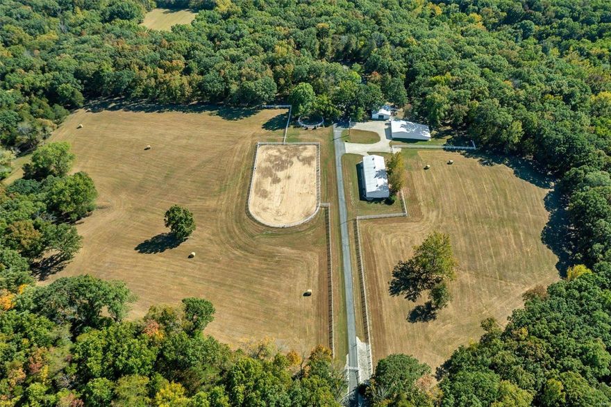 Situated on 135 gently rolling acres & nestled in a 20-acre gated clearing you will find a horse lovers paradise! Full brick, 3 bed, 3.5 bath custom home w/ +- 4500 sq feet of living space & ALL the extra considerations you'd hope to see in a home of this caliber. Structural features include custom brick & stone exterior, 12in thick foundation, 2x6 walls, cellulose insulation, 30year roof w/decorative vinyl cupula, 6inch gutters, insulated water lines w/hot & cold outside spigots, Hurd casement windows & more. Interior features include a Carrera marble entry, large kitchen w/center island, antique white oak cabinets w/leaded glass fronts, a separate dining area, vaulted great room w/stone floor to ceiling fireplace, large master bedroom, double walk-out finished lower-level w/9 ft pour, brick fireplace & tons of storage. The property features excellent hunting, 3 barns totaling 18 stalls, a breeder's lab, indoor training area & outdoor 115x250 outdoor arena, a machine shed & lien-to.