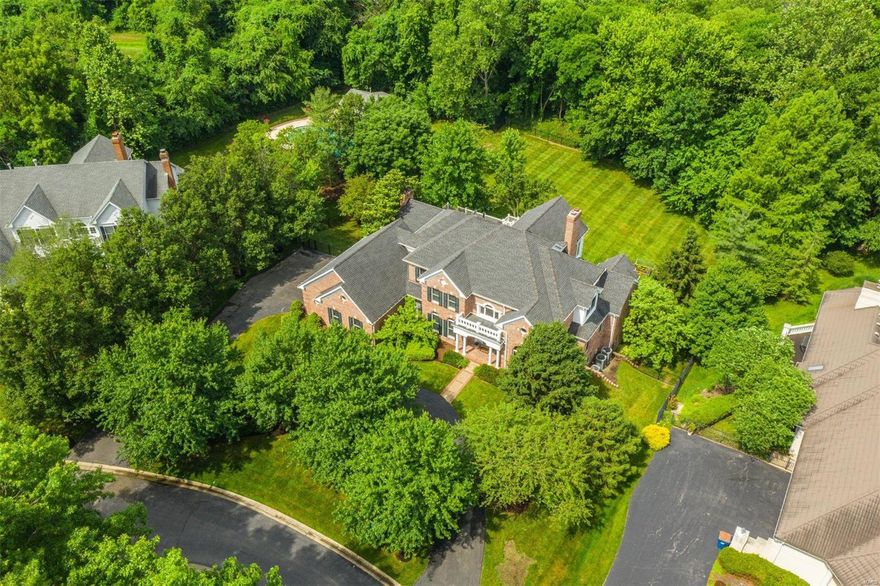 Custom, newer home in the Ladue School District located on a quiet cul-de-sac. 6,635 sq. feet of living space on an ideal 1+ acre level, fenced lot. The foyer features a marble floor & sweeping staircase. 2-story living room with fireplace & a wet bar. Formal dining room. The kitchen features a center island, pantry, gas range, granite counters & opens to a casual dining area & hearth room with fireplace. Gorgeous oak floors. Off the back of the house is an expansive maintenance-free deck with stairs that lead to the yard. The main floor primary bedroom has two walk-in closets & a newly renovated bath with custom shower, soaking tub & granite-topped double vanities. A paneled office completes the 1st floor. 2nd floor with 3 bedrooms & 2 full baths. Freshly painted throughout with new carpeting in the master bedroom & 2nd floor. Walkout lower level with recreation room featuring a fireplace & wet bar, billiards room, plenty of storage, 2 bedrooms & 2 full baths. 3-car oversized garage