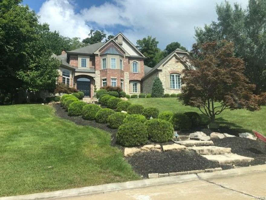 Privately set in a premier golf community, this home features main floor master suite, laundry, kitchen with island, double ovens/dishwashers, and subzero refrigerator. Main also has large dining room and breakfast area, gorgeous cherry paneled study, hearth room w/ vaulted ceiling & 20’ high great room with breathtaking view of an outdoor waterfall.  A dual stairway leads upstairs to 3 addl bedrooms & 2 bathrooms. Downstairs you will find 2 bedrooms and rec area with large drop-down projection screen and incredible sound system that is wired throughout the house, inside and out.  Home is furnished with several oversized fireplaces, massive storage space, crown molding, and plantation shutters throughout.  Flooring is almost entirely wood or marble on the main and upper level with limestone floors in the finished downstairs. Outside, stone siding & A+ landscaping surrounds the home which is overlooked by a year-round covered pool w/ 12’ spa inset & 1100 sq ft amenity filled pool house.