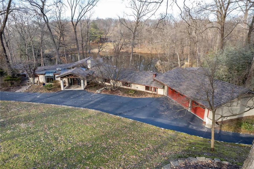 Executive waterfront home in Arrowhead Estates. Three acre resort-like setting with spectacular lake views, private dock, waterfall, fire pit, hot tub, saltwater pool, & gazebos. $400k in recent upgrades. Mid-century modern design. Sunken family room w/ floor-to-ceiling windows & stone gas fireplace. Gourmet kitchen w/ stainless steel appliances & granite countertops. Luxury master suite w/ views, walk-in closet, marble shower, tub, & dual marble vanity. Secluded family room w/ fireplace & wet bar. Cabana bathroom w/ steam shower. Finished lower level w/ home office, gym, & hidden walk-in safe. Wine cellar. Vaulted ceilings. California Closet. Elfa organizers. 14x10 greenhouse w/ water & heat. New roof/gutters (2019). New HVAC (2020). Fast recover water heater (2019). Fresh paint (2019). New windows/skylights (2019). Newer patios/decks. 31 new exterior lights. Stone seawall. Fishing. Boating. Golf cart community w/ tennis court. Walk to Faust Park, shopping, & restaurants.