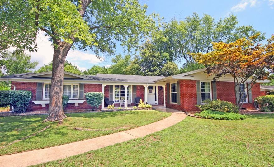 This 3-BR & 2-BA all-brick ranch in Claymont subdivision has mature shade trees & lush greenery.  A covered front porch is a warm welcome.  Etched-glass sidelights & matching front door frame the foyer. French doors open to the LR/study. Hardwood floors flow through the main living spaces. Extra-wide sliding doors in the great room let the outdoors in & walk-out to an outdoor living space w/covered & uncovered areas. Vaulted ceiling spans from the great room to the kitchen, which has custom maple cabinets, crown molding, center island, granite countertops & stainless appliances. Large master suite walks out to the outdoor living space & has a beautifully remodeled BR w/tile flooring, deep soaking jet tub w/glass block window above, separate shower, & walk-in closet. Lower level has an enormous amount of finished & unfinished living space.  Add’l highlights include a rear 2-car garage, newer roof, 2nd full bath w/double bowl vanity, generous closet space in the bedrooms & much more!