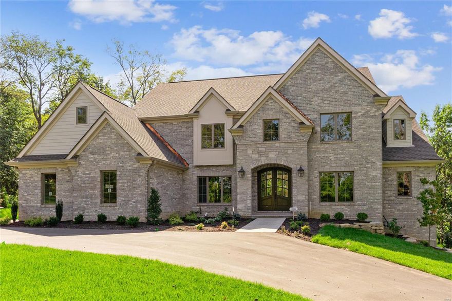 Across from the lush greens of Sunset Hills Country Club & the 43-acre Busch Conservation Area, this custom home by Rehnquist Design & Build is a true masterpiece. Located in the prestigious Mill Hill subdivision, this newly constructed home seamlessly blends unparalleled design & sophisticated comfort. Spanning 6,980 sq ft, this residence boasts 5,400 sq ft across the main & upper levels, & an additional 1,580 sq ft of finished space in the lower level. Thoughtfully curated high-end finishes & custom cabinetry elevate the open floor plan, while expansive windows bathe the interiors in natural light. The 1st floor master suite serves as a private sanctuary, with three full suite bedrooms & a versatile bonus room on the 2nd floor. Outside, a vaulted, covered veranda overlooks the lush backyard, ideal for elevated entertaining. The finished lower level includes a guest suite, entertainment area, wet bar, & full bath, all crafted to the same exacting standards. Duplicate MLS #24057980.