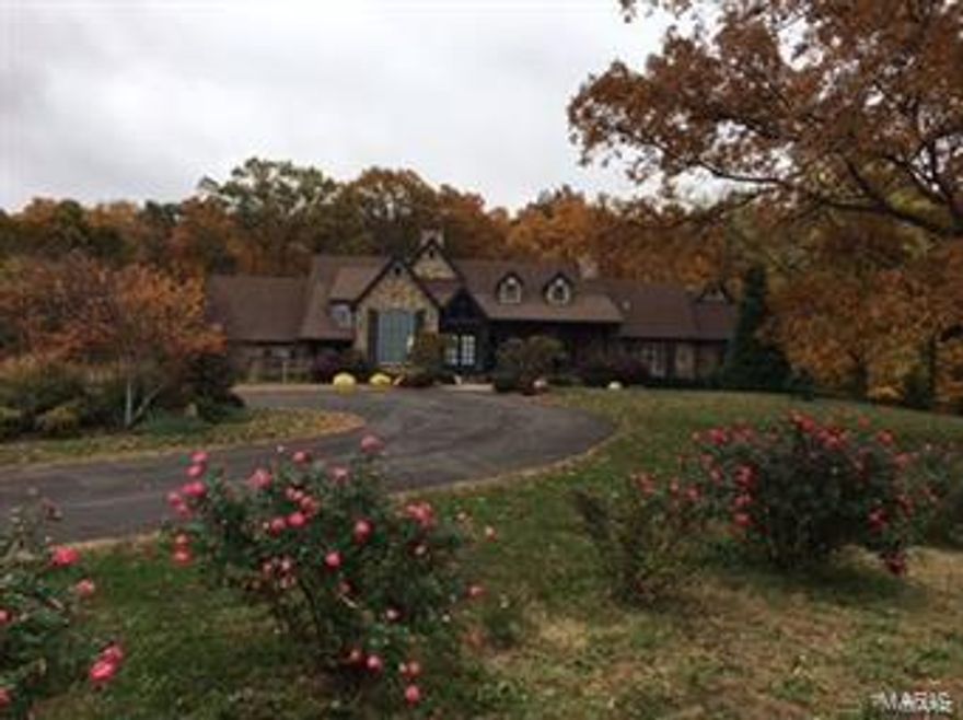 This is a stunning custom built home on private 3 acres with lake frontage.  The home has 6-7 bedrooms, 4 full baths, 3 half baths, 3 fireplaces, newly added theater room, 36x18 salt water pool, hot tub, and so much more!  The new home owner will have privileges to the 1800's log cabin, complete with huge stone fireplace, full kitchen, 2 baths.  Great for weekend guests!  There is extensive hardscape and landscape on the property with a stone outdoor fireplace.  This is a true must see to appreciate the inside and outside workmanship of this one of a kind home. Horse barn with 2 bedrooms, 1 bath apartment.  Indoor/outdoor riding arena.  Cabin with 1 bedroom, 2 bath, 2 fireplaces.  2 wells.  Fiber optic internet.  Man made waterfall into lake.  Custom stone bridge.