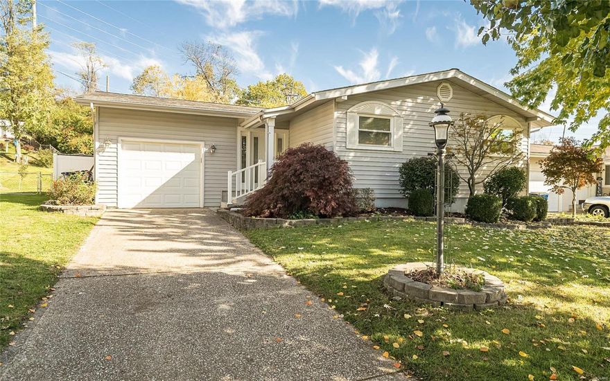 Attractive 1 bedroom 1 bath ranch with open floor plan and beautiful private fenced backyard. Gracious foyer welcomes you to a large carpeted living area and spacious dining room with hardwood flooring. Twin sliders offer great natural light and access out to a generously sized newer concrete patio with composite steps and railing. Updated bath offers a walk-in shower with fold out bench, luxury vinyl plank and an adult height sink and comfort commode. Bedroom has hardwood floors. Newer vinyl windows and roof give updated curb appeal to this mid century home. Great natural light plus recessed lighting in most of home. Dining area could be converted to 2nd bedroom. New refrigerator stays. One car garage with EGDO. Close to highways, schools, restaurants, shops and more!