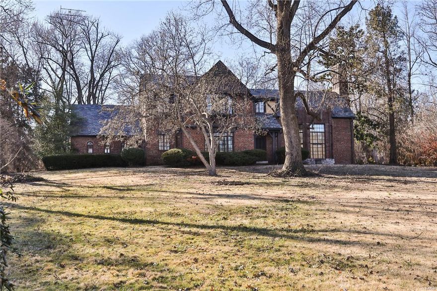 Fantastic opportunity in prime Ladue location, minutes to downtown Clayton.  1.989 acre, dividable lot.  Build new or update the impressive tudor that currently sits on this stunning lot.  The great room is a show stopper with vaulted ceilings, stone fireplace, oversized lead glass window and terrazzo floors. It is screaming to be restored to it's former glory.  Elegant separate dining rm with terrazzo floors and wide molding. Overlooks the sprawling front yard with screened gazebo. The kitchen has been updated with new cabinets, stainless appliances and Corian counters.  Done tastefully to preserve the original essence of the home.  There is also a 2 story, brick addition which includes a main floor family room with floor to ceiling windows overlooking the vast, private lot.  The 2nd floor has three beds including a sizable master with adjoining sitting room. Would be a great dressing room/ bath for the master.  2 car attached garage. Don't miss this opportunity before it is gone.