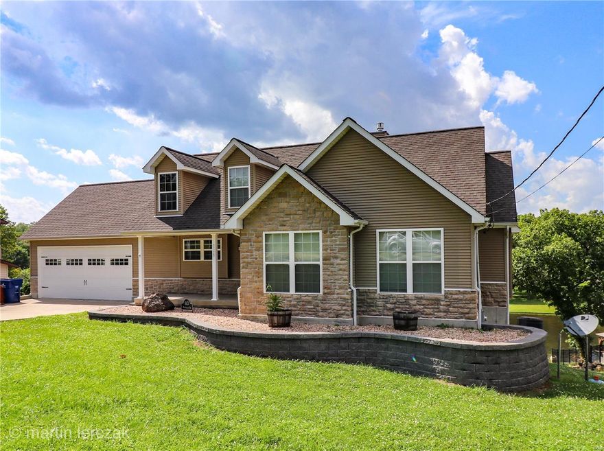 MOTIVATED SELLERS! PRICE REDUCTION! Lake Front Home Move In Ready!  Looking for a full time residence or just a weekend home on a ski lake?  This home has lots to offer.  Over 2300 sq feet of finished living space with 90 ft of lake frontage.  Open floor plan with vaulted ceilings.   Master Bedroom Suite includes double sinks, walk in closet, Jacuzzi tub and separate shower.  Basement is recently finished with a family room, bedroom, sleeping room, full bathroom and storage.  Spectacular View from the deck and patio.  Home features a concrete seawall, boat dock with a sundeck, patio and storage.  Terre Du Lac offers access to 15 lakes, Country Club, Two Golf Courses,swimming pool and tennis.