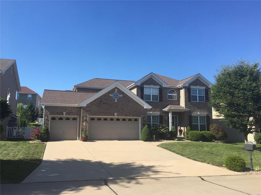 This gorgeous 2-story has all the bells and whistles.  When you walk in, you immediately feel at home.  There are warm HWD floors throughout most of the main floor.  There is plenty of room to entertain in the luxury kitchen featuring granite countertops, 42” cabinets, dry bar, buffet area, and gorgeous dining room.  In the great room, there is a gas fireplace and 6 window bay with tall windows which overlooks the level, fenced yard.  Take the beautiful, wrought iron spindled staircase up to the luxury master suite.  Walk thru the double doors and find a spacious retreat with coffered ceilings, amazing closet, and luxury bath featuring a soaking tub and adult height vanities.  There are 3 additional bedrooms and a full bath (with a double bowl vanity) upstairs, all wonderfully decorated.  Don’t forget to check out the main floor laundry, office area, 3-car garage, upgraded lighting throughout, and so much more.  This sought after floor plan in this neighborhood won’t last long.