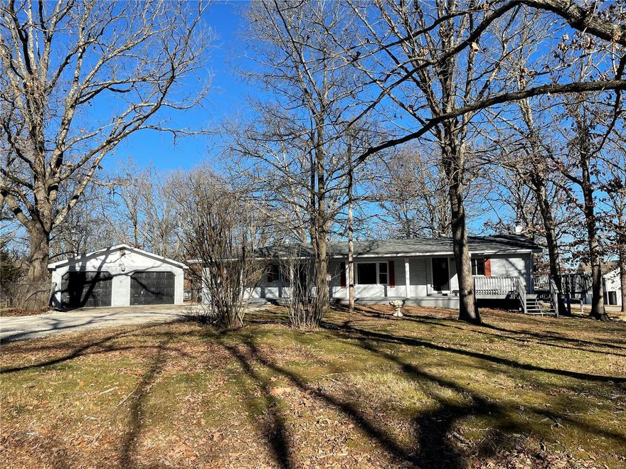 A beautiful and tastefully remodeled home located on a generous chain link fenced corner lot on a quiet street with a large detached garage! This inviting home has been fully refinished with attention to every detail. Featuring rich wood laminate flooring in the main areas of the home and new carpeting in the bedrooms. The covered front porch opens to a spacious entry way with built-in bench and coat rack and continues into the enormous living room with a bay window overlooking the front yard. The gourmet kitchen boasts stained butcher block counter tops, stainless steel appliances, a solid copper farm sink, custom tile back splash and a frosted glass walk-in pantry. All bedrooms including the master have built-in closets with plenty of room for all of your clothes. There is lots of additional storage space in in the walk out basement. This home has absolutely everything you could possibly need (including a new roof!), call today to schedule a viewing or for additional information.