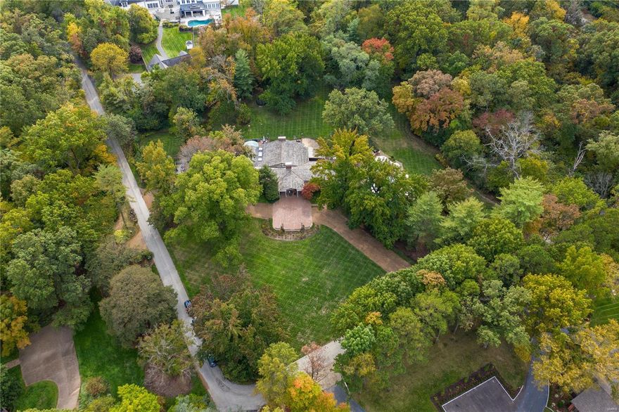 An opportunity is coming your way in Huntleigh.  Architecturally interesting ranch home, perfectly situated on a private 4.9 acre lot of level green space, beautiful trees, patios, terraces, deck & pool, is waiting for your personal touch! The home, perfect for entertaining, boasts 4,625 sq/ft on the main level & an additional 1,500sq/ft on the walk-out Lower Level.  Current floor plan provides a Living Room/Library with built-in bookcases, fireplace, Dining Room with wall of storage closets and art deco skylight, dramatic stepdown Great Room with soaring ceiling, exposed beams, fireplace & walls of sliding doors opening to the exterior living space. Kitchen has great space including breakfast area with large bay window. Opening to the patio, the Master Suite offers a large walk-in closet, his and her baths. Two additional bedrooms & 2 baths complete this floor. Lower level includes a Recreation Room, kitchenette, 2 bedrooms & 2 baths, office/exercise room & laundry. Three car garage.