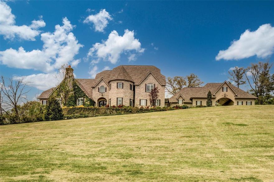 Situated on a quiet cul-de-sac, this stately home offers over 8500 square feet of luxurious living space. This custom build sits on a private acre lot with stunning views. Full of exquisite architectural details including detailed millwork, oak hardwood flooring, plantation shutters & soaring ceilings. Professional grade kitchen with custom cabinetry & high-end appliances open to the breakfast room, wet-bar & hearth room with a stone gas fireplace. The main floor master bedroom wing is sure to impress with coffered ceilings, a balcony, expansive master bathroom & attached den with vaulted ceilings & a gas fireplace. A private office and additional bedroom with ensuite bathroom complete the main floor. The impressive lower level is perfect for entertaining with a large bar area, recreation room, home theater, additional office/bedroom, wine/cigar room, full bath & home gym with a sauna. The lower level walks out to the resort-style pool & covered porch with a wood burning fireplace. Additional Rooms: Mud Room