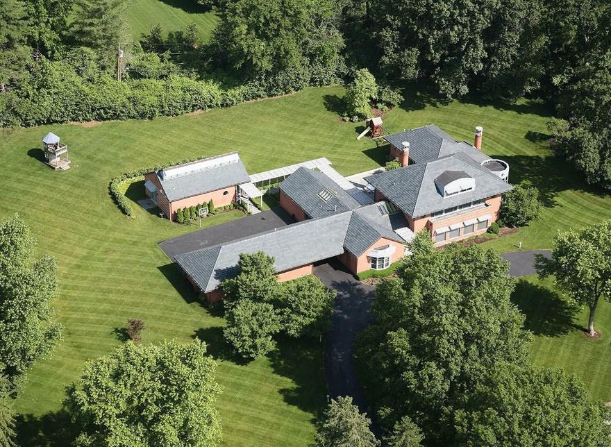 This newer contemporary home is set on 3 acres in the sought-after Somerset Downs neighborhood and designed by Louis Saur with a recent guesthouse addition. The U-shaped house is centered by a 25’x50’ blue stone patio with an inspiring great room as its centerpiece. Skylights and expansive windows wash the rooms in natural light & varying ceiling heights blend dramatic & intimate spaces. You’ll find two of everything in the chef’s kitchen with designer appliances, a center island, marble counter tops & custom maple cabinetry. The master suite is a sanctuary with a marble fireplace, His & Hers baths/dressing rooms, heated flooring & skylights. An entertainment center, wet bar, exercise room & en suite bedroom define the finished lower level. Additional features are a Ludowici tile roof, Lutron electronics, central vac, security, irrigation system, 5-car heated garage. 6,758sf on main flrs, 2,600sf in LL, 1,200 sf in guest house combine for 10,000+ sf of luxury living.