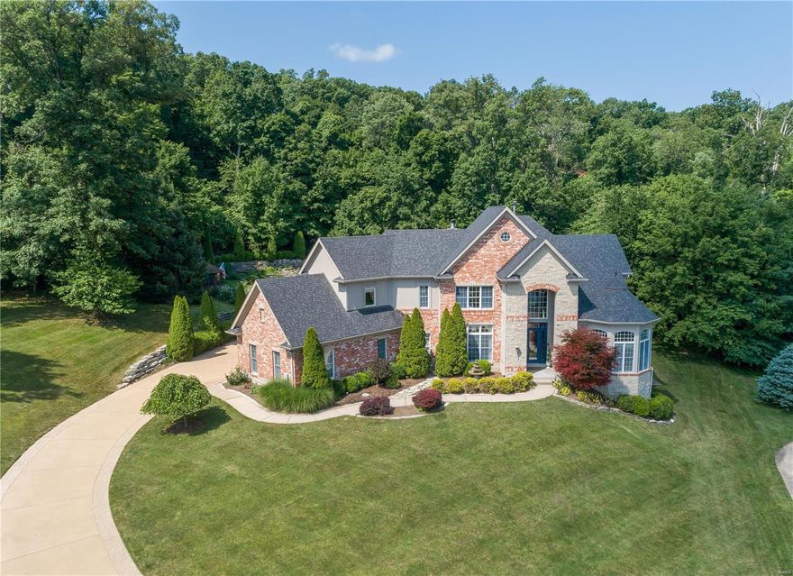 Spectacular 1.5 sty on over 2 acres backing to woods. 1st floor w/10' ceilings, 2-story entry with marble floors. Dining room and Office off foyer, 2 sty great room w/ wet bar & fireplace, ALL w/teak hardwood floors. Kitchen w/ 40' feet of quartz counters, pantry, Kitchen Aid and Jenn-Air SS appliances. 1/2 bath and laundry/mudroom off kitchen. Breakfast room w/some radiant heated floors. Hearth Room w/ limestone fireplace. King & Queen Suite w/coffered ceiling, custom crown molding, French doors to the patio, MSTR bath w/dbl bowl vanity, dual W/I closets, Jacuzzi tub, massive W/I shower, Kohler toilet & bidet. Upper Level has loft, bdrm w/ W/I closet & full bath. 2nd and 3rd bdrms w/ shared bath w/ private vanities. LL w/ full kitchen, gym, media room, craft room, large rec area, full bath, walkout w/ some radiant heated flooring.  The backyard is amazing, private, and perfect for all of your outdoor get togethers, the large inground pool is self-cleaning, salt water and 10 feet deep.