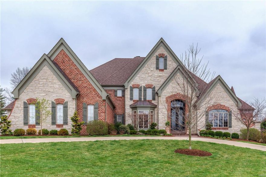 Magnificent French Country Estate home with over 8200 sf of living space! Extraordinary 9’ wrought iron double doors lead to grand 2-sty marble foyer, library-paneled study, elegant dining room & spectacular great room with dramatic wall of windows, marble see-through fireplace & built-in bookcases. Designer kitchen with professional quality appliances, glazed cabinetry, granite countertops, cooking alcove & center island adjoins light-filled breakfast room & stunning hearth room with 2-sty wall of windows & floor-to-ceiling brick & stone fireplace. Coffered master bedroom suite features wide bay window, 2 walk-in closets & lavish bath with shower spa & Jacuzzi. Front & rear staircases access 4 additional bedrooms, 2 with ensuite baths & 2 with Jack n’ Jill bath. Walk-out Lower Level includes recreation room with wet bar, family room with fireplace, media room, workout room & full bath. Impeccably landscaped 1+ ac lot with deck, patio, pool, fire pit & 4-car garage with porte cochere.