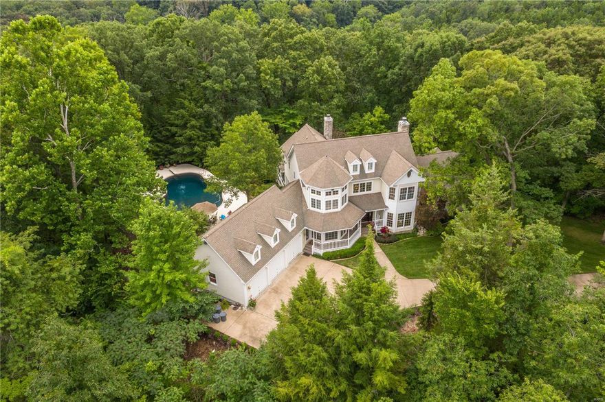 Discover the epitome of country estate living on 16.35 acres, surrounded by undeveloped woodlands. Meander along 1,250’ of cedar wood fencing lining the gated & paved private drive, which leads to this masterpiece designed by Lauren Strutman. The estate boasts 3,727 sqft of open-concept living. It features a 2-story living room with a stone fireplace & offers panoramic views of the lush grounds. The kitchen, adorned with custom oak cabinets and granite counters, adjoins to a sunlit breakfast room and a family room overlooking the saltwater pool & gazebo. Retreat to the main-floor primary suite, featuring dual closets & a luxurious updated bath. The finished lower level, with a deep 10-foot pour, is a recreational haven with a wet bar, billiards room & rec room. 3-car attached garage. Additional amenities include a detached 4-car garage with finished 2nd-story space, a restored 1890 log cabin & a multi-purpose barn. For added versatility, subdivide the property into 3+ acre parcels.