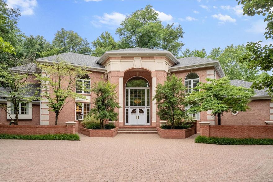 Don't miss this exquisite brick home in sought-after Sheffield Estates, steps away from Priory. Enter a 2-story foyer that flows directly into the light-filled, formal living room with built-in bar. Formal dining room moves into the gourmet kitchen with island, granite countertops, plenty of storage, and tall ceiling with skylights. Office nook connects the kitchen to the bright breakfast room. The stunning atrium-style living room offers views of the manicured grounds. Continue to the main floor primary bedroom wing with a wood-paneled study,  dramatic tray ceiling, large windows, and primary bath with two vanities, spa tub, and his/hers closets. Upstairs, find 3 more sizable bedrooms, each with walk-in closets and ensuites. The partly-finished LL provides more room with rec room, full bar and additional bath. Outside, enchanting paths among groomed gardens, mature trees, and bubbling fountains. The 4-car garage, custom pool, and accompanying pool house complete the private retreat.