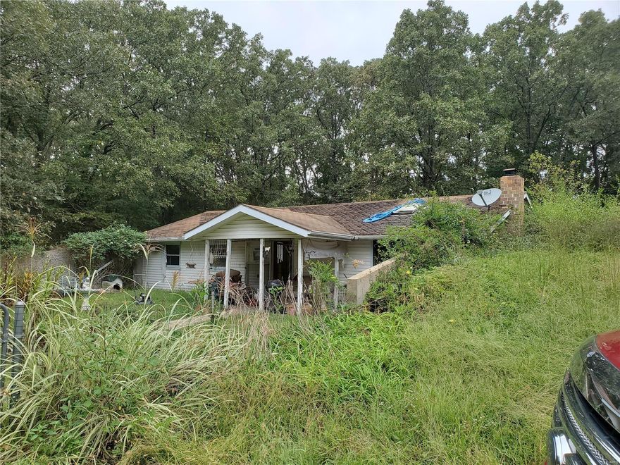 3 bedroom, (1 bedroom does not have a window) 2 bath earth home on 4.7 acres. Home offers open kitchen & living room with wood burning fireplace in living room. Property is wooded and has shared driveway. SOLD AS IS!