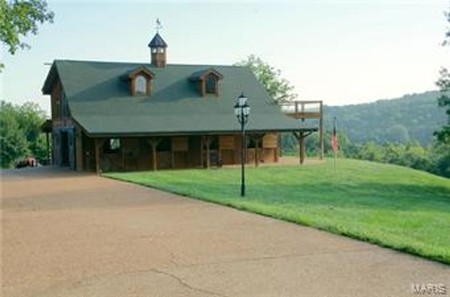 Beautiful 150 ac estate is currently set up as a pristine equestrian facility but has many other possibilities including hunting, fishing, ATV riding or permanent residence. Included w/ the property are 2 houses, heated horse barn w/ water & electric, 6 fenced pastures w/ watering systems, horse runs, & 8 miles of riding trails throughout property, riding arena, two 50X80 metal buildings, 1 acre pond w/ fountain & lights, private gate, paved driveway, two live creeks &nbeautiful views. The 2 story 50x50 horse stable is second to none. It has 5, 12x12 stalls w/ classic European equine stall fronts, automatic/heated watering system, half bath, wet-bar, & stone/gas fireplace in hearth room. Stable also has deck & over-sized drive thru doors. Both metal equipment storage buildings have concrete floors &one is equipped electric, heat, water, air compressor lines. A caretaker/guest house w/ 2 car garage is also on the property. This entire property is surveyed.