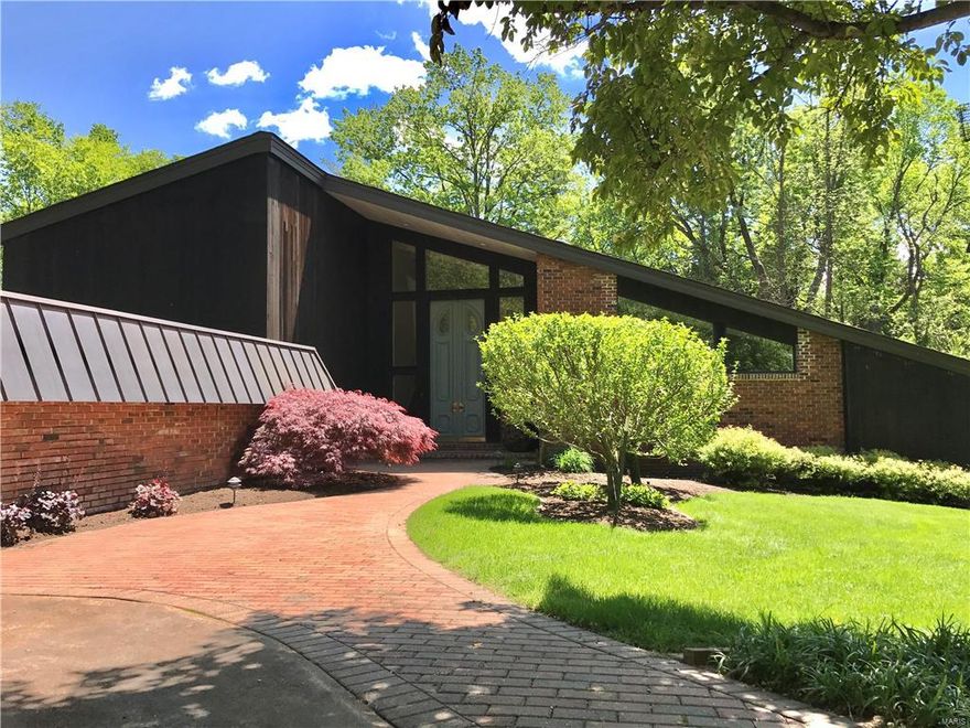 An art collector's dream; spectacular modern build nestled on a lush, quiet cul-se-sac! 12' antique oak doors, vaulted great room featuring wall of windows that bring the lush backyard inside! You'll love entertaining with the open floor plan, high ceilings & incredible flow. Walk out onto the composite deck with designer rails spanning the length of the home. Enjoy the outdoors all yr long with the built-in 60" TV & XL hot tub! Fab 1st fl master ste with spa like bathroom,private walk out access to deck & impressive upgraded XL walk-in closet! Extra bedrm on the 1st fl being used as a priv home gym could be a fabulous office, playroom etc.! Cozy family room offers deck access, fire place & bright windows! Large din rm off the kitch, Brazilian cherry floors & first floor mudroom kitch! 3 addtl bedrooms and 2 full baths on the 2nd fl, finished basement, and high end appliances in the kitch! New roof & copper gutters in '14. Walk, don't run; there's nothing like this! And LADUE SCHOOLS!