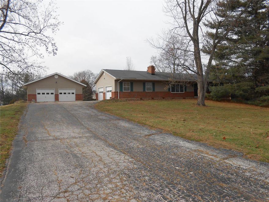 Move-in ready 4 bedroom 3 full bath ranch home.  Sitting on 1.879 beautiful park-like acres.  There is an attached over-size 2-car garage plus another newer over-size two car garage being used as a work shop.  Wood burning firep0lace in living room.  Partially finished lower level has a walk-out. New carpeting in the finished area which measures 27/x21 and could be used for a family room, game room or whatever you want. Large deck in back is great for entertaining.  Kitchen has been rehabbed and has slate-colored appliances.  Slate refrigerator stays, too! Sliding doors from country kitchen open onto the deck as do the sliding doors from the master suite.  There is so much to like about this home that you just have to see it to appreciate all it has to offer!