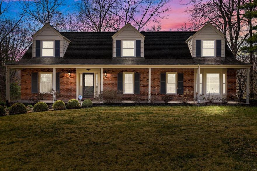 Located in Ladue, 9830 Wild Deer is a spacious 3,042 sq ft Cape Cod style residence featuring 4 bedrooms and 3.5 bathrooms. This home has undergone significant updates, including modernized kitchen and bathrooms, some newer floors, roof, HVAC, windows, and deck. A large covered porch graces the front.  The foyer leads into a large formal living room and a dining room with bay window. The kitchen is highlighted by custom cabinets, soapstone countertops, stainless appliances, two appliance bays, a large peninsula with wood countertop, and plenty of storage. The kitchen opens into the family room with built-in bookcase, wet bar, and fireplace. The sunroom features floor-to-ceiling windows and heated floors and leads to the deck. The main level also has a primary bedroom and a bath with heated floors. The upper level has a large ensuite, two additional bedrooms, a guest full bathroom, bonus/office area, and a large walk-in closet or 5th bedroom. Superb landscaping. Rec area in lower level. Additional Rooms: Sun Room
