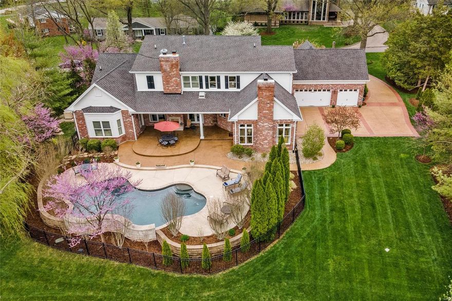 Cape Cod living in the heart of Frontenac, crafted by the reputable Robert Berkley & Son Development. No amenity overlooked, offering today's discerning buyer the best of indoor & outdoor living. Millwork, custom cabinetry, 9-10' ceilings and whole-house generator speak to the integrity throughout. 5 bedroom suites including a primary suite on main, 3 on the upper and one in the lower plus 2 laundries. Full finished lower level with egress windows, office, family room, bedroom, billiards and bar. Private outdoor covered veranda flowing seamlessly from main floor complete with pool & fireplace - all accessible from multiple areas of the home, delivering meticulous outdoor spaces with exclusive privacy. 3 car rear entry garage plus extra parking for visitors. Experience the best of Cape Cod living, delivering exquisite spaces both indoors and out. Ladue Schools and stellar private location off notable Geyer Road.