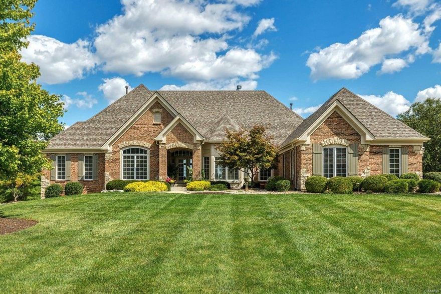This spectacular brick & stone ranch home features over 5000 sq ft of living space enhanced by distinctive design elements & updates throughout. Impressive hardwood foyer leads to study with custom built-ins, formal dining room with wide bay window & stunning great room with architectural columns, cast stone fireplace & dramatic wall of windows. Designer kitchen with granite countertops, 42” white cabinetry & KitchenAid appliances adjoins breakfast room with butler’s pantry & convenient planning center & hearth room with groin vault ceiling, full-height stone fireplace & bay window. Coffered master bedroom suite with luxury bath plus a 2nd ensuite bedroom complete the main floor living quarters. Walk-out Lower Level includes recreation room with wet bar & see-through brick & stone fireplace, family room with fireplace, game room, 2 additional bedrooms & full bath. Atrium doors open to outdoor living area with resort style pool surrounded by landscaped gardens & stamped concrete patio.