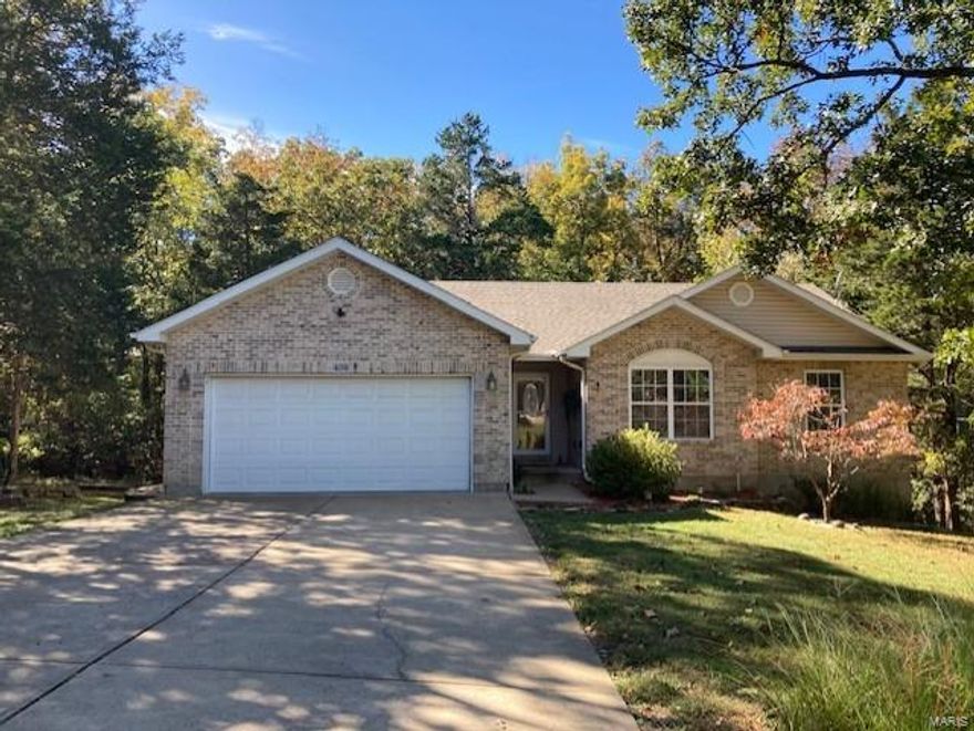 This beautiful 4 bed 3 bath home with totally finished lower level. sits on almost 3/4 of an acre.  All new hard wood floors upstairs with an awesome covered deck right off the kitchen with steps  taking you down to a covered patio and fire pit.  Awesome Wood burning fireplace in great room.  The lower level is totally finished with a family Room, kitchen , full bath, bedroom and office/den and additional storage space.  The additional lot, has now been combined to the other lot with 1 TI#.   The separate living quarters in the lower level are perfect for that family member that needs a bit of privacy but not quite ready to move out or perfect for visiting overnight guests. This home shows pride of ownership throughout and it will not disappoint.   What a unique opportunity to live in a gated lake community with all the amenities' and still feel like you are living in the country with a gorgeous park like lot attached and a wet weather creek that runs behind your property.