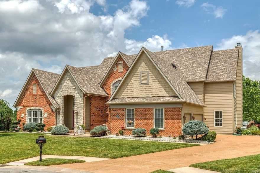 Spectacular 1.5-sty lakefront home in premier gated neighborhood. Impressive hardwood entry foyer opens to private study, formal dining room framed by architectural columns & stunning 2-sty great room with marble fireplace & dramatic bow window. Designer kitchen with granite countertops, 42” natural cherry cabinetry, stainless steel appliances, butler’s pantry & convenient planning center adjoins light-filled breakfast room with bay window & atrium door to deck & hearth room highlighted by floor-to-ceiling stone fireplace. Coffered master bedroom suite offers an appealing retreat with His & Hers walk-in closets & luxury bath with jetted tub. The 2nd floor extends the living quarters with 3 additional ensuite bedrooms & loft sitting area. Lower Level entertainment space includes recreation room with see-through stone fireplace, game room with wet bar, family room, media room, workout room & guest suite. Situated on a .85-acre cul-de-sac lot with deck, patio with firepit & 3-car garage.