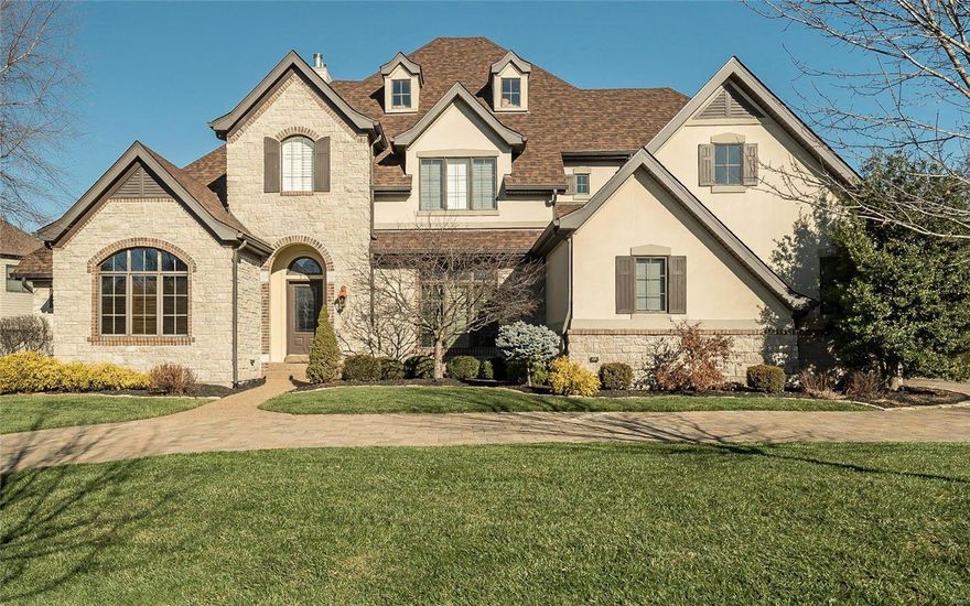 This dramatic 1.5 story Country French Oxford Plan Masterwork Series offers superb design and exquisite finishes throughout +6000 sq ft of finished living space. This Miceli built display home offers exceptional craftsmanship and custom millwork. The two story great room offers a fireplace, built in bookcases and wet bar that joins the large kitchen. A cooks dream kitchen includes an open floor plan, granite counters, stainless appliances, large pantry, custom cabinetry and breakfast room adjoining the beautiful hearth room. This lovely 4 bedroom, 4.5 bath home features a coffered ceiling in the master bedroom suite with a luxurious bath. The upstairs offers 3 bedrooms including a bedroom suite and loft area. The finished lower level offers a gas fireplace, wet bar, full bath, extra sleeping area and plenty of storage. The professionally landscaped yard is complete with a gorgeous salt water pool, covered patio and a hot tub that is perfect for family entertaining.