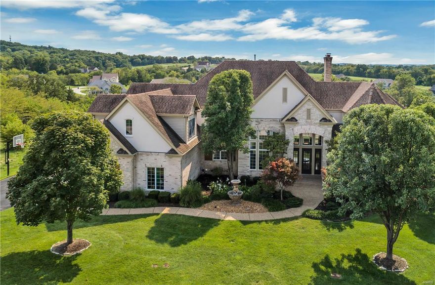 This fabulous 1.5 story with unparalleled design & amenities sits on a park-like 1.2 acre lot with majestic views. There is space galore with over 9000 square feet of living space. The foyer, dining room, great room & library are all 2 stories in height with incredible moldings & built-ins. The library has a ladder up to a private loft with built in shelves. The main floor master features a coffered ceiling, luxury bath & fabulous walk-in closet with closet systems. The kitchen is a cook’s dream with a 5-burner gas cooktop, sub-zero refrigerator & a massive breakfast bar. The upper level features 3 bedrooms, 2 full baths & a bonus room. Enjoy entertaining in the lower level with the huge wet bar, rec room, media room & complete in-law suite. A resort-like backyard includes a large gunite pool, spa & gazebo. Don’t miss this