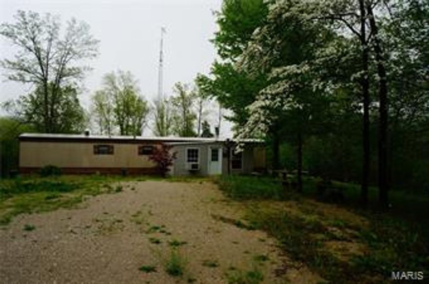 Everything…you’ve ever wanted in a home comes with this delightful 2 bedroom, 1 1/2 bath mobile home. Huge living room with wood burning fireplace, all electric HVAC system, huge deck and patio area to enjoy watching wildlife, towering trees.  Country fresh setting, very quiet comes with 18.3 ac. +/-.  Along with sheds and 24 x 24 barn for your tractor and toys. Large mud room There is a 20’ drainage easement for the spring located on this property. Additional Rooms: Mud Room