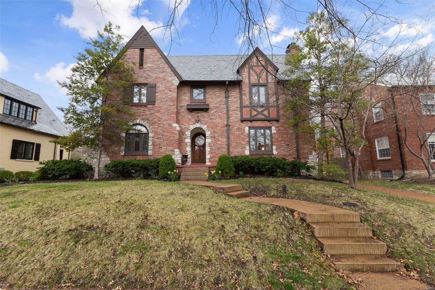 This Clayton 2-story home is absolutely charming! The combination of Tudor architecture with stone accents gives it a timeless & elegant look; the solid arched wood door with stained glass really sets the tone for the quality inside. The sunken living room with elevated, beamed ceilings & many large windows would certainly be a great space for relaxing or entertaining, especially with the lovely gas log fireplace.  The dining room connects so seamlessly with the kitchen & breakfast room—perfect for family gatherings. Plus, the cozy family room with built-in bookshelves adds a personal touch. The 4 bedrooms & 2 full baths upstairs make it ideal for a family, & the finished basement space seems like a perfect bonus for extra activities or an office. The landscaped yard, sweet patio, & privacy fence create an inviting outdoor retreat, & the 2-car garage is a nice added convenience. With a great neighborhood & walkability, this home sounds like a dream!  Consider making it your own!