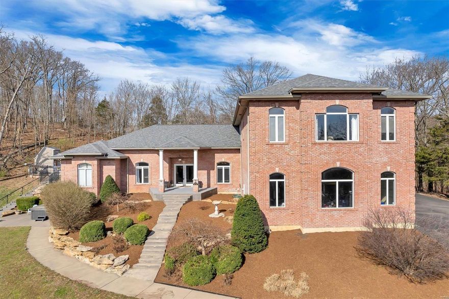 Perfect Home for Entertaining! This nearly 8,000 sq. ft. custom-built home on 3 acres offers 6 bedrooms, 7 bathrooms, & a 4-car garage. The mother-in-law quarters, ideal for multi-generational living, includes a family room, kitchen, bedroom, and baths with stunning views. Enjoy the outdoors with an inground pool, pergola-covered patio, stone fireplace, outdoor kitchen, & a large 4-season enclosed porch with wet bar.
The finished lower level features a commercial bar, family room, bathroom, & extra bedrooms. The newly renovated gourmet kitchen with granite countertops and copper sink is a chef’s dream, & the main floor master suite includes a luxury bath with whirlpool tub. Located in the Rockwood School District with Jefferson County taxes, this home also has a newer roof (2018), sprinkler system, and intercom. Newer upgrades also include- New Ac on Main level (2024).  With laundry rooms on two levels, this multi-generational home is a must-see!