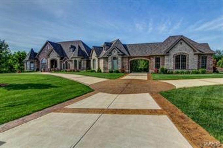 Come and see the finest quality your money can buy! Bax Custom Homes has been building the finest homes in the St. Louis area for 28 years! This home is their own personal masterpiece! Inside & out you will find attention to detail that you will not find in other homes at any price! From the exquisite trim & millwork to the exceptional full masonry exterior of brick & stone, you will find only artisan craftsmanship completed with superior care from top to bottom! Here are just some of the unique features you will enjoy: over 8,300 sq ft of finished living space, 4-bedroom suites, each with private bath, 3 half baths, 5 car garage, plus Porte-Cochere, circle driveway, 10' basement pour, 10' main floor, 8' Bellagio Interior doors, 10' solid mahogany entry door, covered outdoor hearth room, stamped patios, suspended stamped concrete decks w/wrought iron rail, theater w/stadium seating. The list of amenities goes on & on.  Call and schedule your personal tour today!! COOL: 14 SEER+