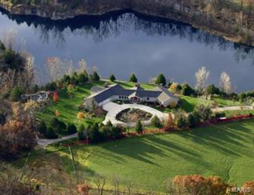 Located in Callaway County, MO a  225 ac Country Estate with Stately Home overlooking a Large Quarry Lake.  Bachelor Creek Valley runs through center of farm creating natural environment for wildlife.   Highlighting the property, a large, clear quarry lake with docks fully stocked.  Quality of material and craftsmanship in 8000 sq. ft. finished home.  The exquisite grand kitchen and hearth room/breakfast area combo w/ pine vaulted and exposed beam ceilings was designed for entertaining. 3 addtl wood burning fireplaces.  Each room on the South end of the home has a door that exits to the wraparound deck for outside views of  lake and waterfall.   Irrigation system on property maintains grounds and gardens.  Also, a two story guest home, vintage loft barn with coral, large machine shed, heated garage with workshop and outbuildings.   This Property is your Own Private Resort with Hunting, Rec, Horse Back Riding, Boating, Fishing, Swimming, and Diving all with Lavish Accommodations.