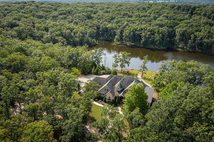 FIRST TIME OFFERED, TURN-KEY, COMPLETE WITH ALL FURNISHINGS,  ELEGANT CUSTOM-BUILT HOME, 30 X 40 WORKSHOP W/CONCRETE FLOOR, 5-ACRE LAKE IN-GROUND POOL ALL ON 103 WOODED ACRES. HOME FEATURES A GRAND ENTRANCE,  CUSTOM BUILT CABINETRY WITH MANY EXTRA FEATURES, GRANITE COUNTER TOPS, STAINLESS COMMERCIAL APPLIANCES,  HAND MILLED WOOD WORK, 2 MAIN FLOOR MASTER SUITES, & 2-FIREPLACES. YOU CAN ENJOY THE VIEWS FROM INSIDE  OR THE WRAP-AROUND COVERED PORCH. THE BACK MULTI-LEVEL MAINTENANCE-FREE DECKS OFFER GREAT FAMILY ENTERTAINING FOR GATHERINGS OR JUST A PLACE TO RELAX OR GO FOR A SWIM IN THE BLUE HAWAIIAN INGROUND POOL. NO DISAPPOINTMENT HERE.