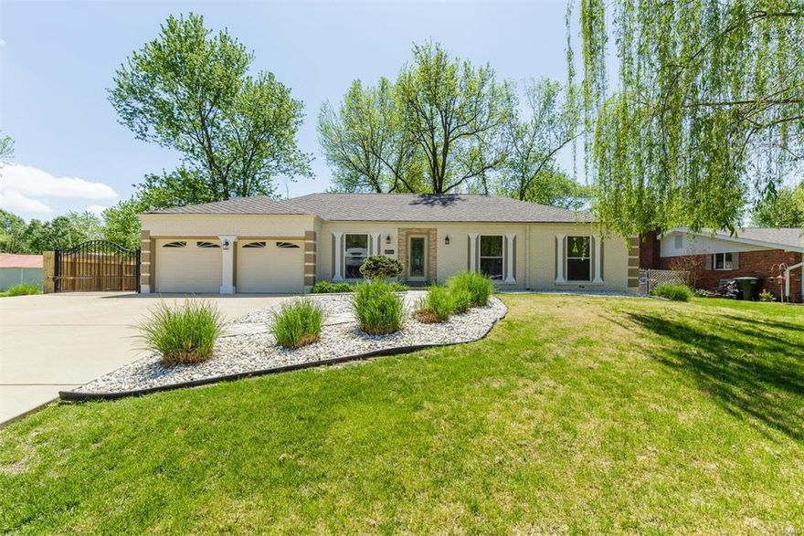 SPECTACULAR  curb appeal and just as exciting on the inside.  Gleaming BAMBOO HARDWOOD floors all throughout and extra wide hallway. Fantastic Kitchen with shaker cabinets, crown molding, granite surface counters, matching s/s appl., newer sink and faucet. Overlooking into the great room above the Fireplace a Huge BRAND NEW 4K 70" TV which is included in sale. Hall bathroom has been updated and wait until you see the luxury master bath. All the windows are newer and carpet in bedrooms, water heater is less than a year old. The basement is partially finished with rec room, sleeping room, full bathroom and storage area. Enjoy barbeques or just relaxing on your private 20 x 20 slate patio overlooking HUGE backyard - level lot - fully fenced.  Even a motorized gate on the side of the house for additional parking. That is just not any new roof - but a designer lifetime shingle. Sought after Rockwood School District and Ellisville municipality has many extra amenities it offers home owners.