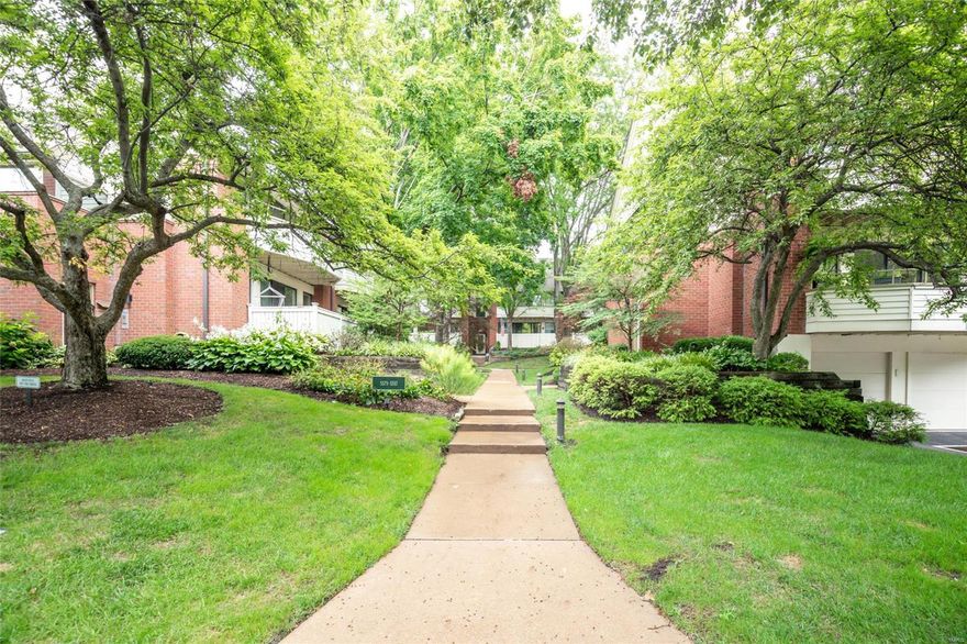 This charming 1st floor condo has it all! The beautiful and lush landscaping is very inviting and this condo is tucked away off Waterman which makes it feel more private. The open concept living room and dining room is very inviting with a wood burning fireplace for those St. Louis winter nights. Hardwood floors and a great porch/ deck perfect for a morning cup of coffee or a nice BBQ.
The kitchen has amble cabinet space and a stainless steel refrigerator and dishwasher. A very nice sized primary bedroom with ensuite and walk in closet is a plus. The 2nd bedroom or office is the perfect size with a full bathroom accessible for guests or from the hall.  Full size washer/ dryer in the 2nd bathroom. Tandem garage parking and large storage in the basement. Easy access to the Central West End/ Kingshighway and Barnes hospital as well as HWY 64. Also close to Washington University and Forest Park. Great walking neighborhood. Location: Ground Level, Interior Unit