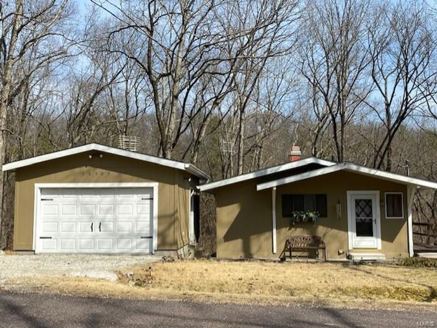 This 2 bedroom, 1 1/2 bathroom cabin is great for a get-a-way or a permanent home.  It is located inside the gated community of Grayhawk.  A new roof and gutters were put on in 2019.  There is access to the large deck from both of the bedrooms.  In the fall and winter cozy up to the wood burning fireplace.  Enjoy relaxing on the large deck that overlooks the woods.  If you need more seating, there is an additional covered deck.  You will love fishing, swimming, boating and enjoying all the amenities of Grayhawk.  There is a 26x12 garage.  This property also comes with Lots 37, 38, 39, 40 and 41 which you can keep or sell for extra cash.