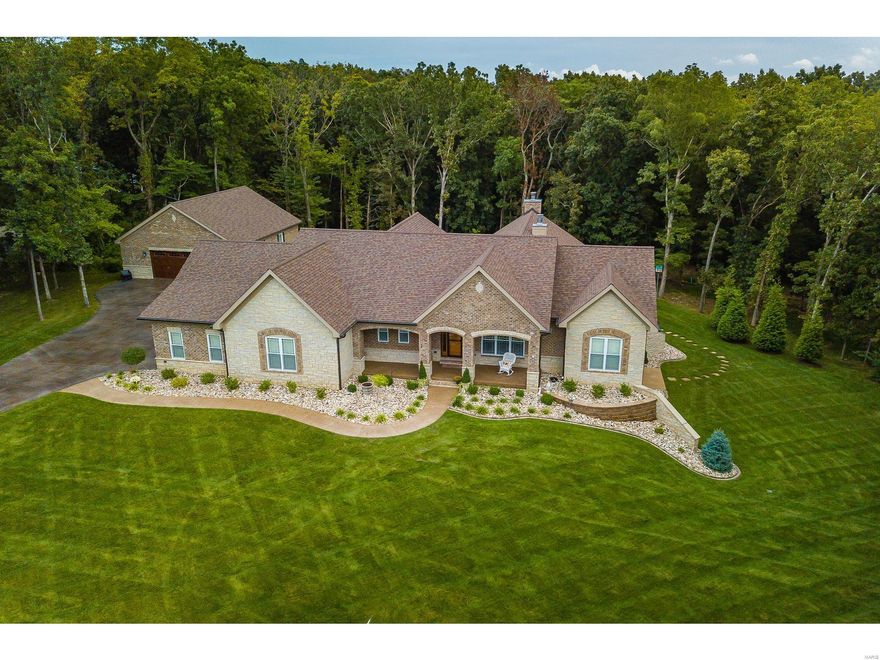 This beauty will not disappoint.  Why go through the hassel of building your dream home when you can have it now.  Gorgeous brick and stone front elevation as you pull up. From the covered back patio with outdoor kitchen, the inground pool and the walk out finished basement with a full bar this one is an entertainers dream. Gleaming harwood floors. Crown molding through out main level.  Custom cabinetry and vanities.  Kitchen boasts large breakfast bar with double oven, cooktop and granite counter tops. At the end of the day you  can retreat to your master bedroom suite with jaquzzi tub, separate shower and double bowl vanity. Geothermal heating and cooling system and heated inground pool.   Oversized attached 3 car garage but don't worry if that is not enough space you have the 35x40 detached garage. No expense was spared on this custom built executive home.