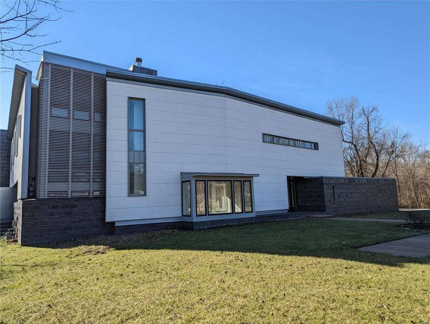 This custom designed contemporary home is a breathtaking and sophisticated work of art. Rising tall and sitting on 3.47 wooded acres, this home features open living spaces throughout. A wood burning fireplace is the centerpiece of the sprawling living room with an abundance of windows and doors offering amazing views of the back yard and patio areas. Step up into the stylish kitchen and dining area that leads to an office and another living area perfect for a family room or gym. Bedrooms are located on the 2nd floor as is the laundry room. The primary bedroom is loaded with closets and the bathroom has a jacuzzi tub, double sink vanity, and a separate shower. Walk out onto the roof and relax with amazing views of the back yard, woods, and tennis court. Additional living and storage space in the basement. Property is lender-owned, is being sold “as-is”, and seller makes no representations or warranties.