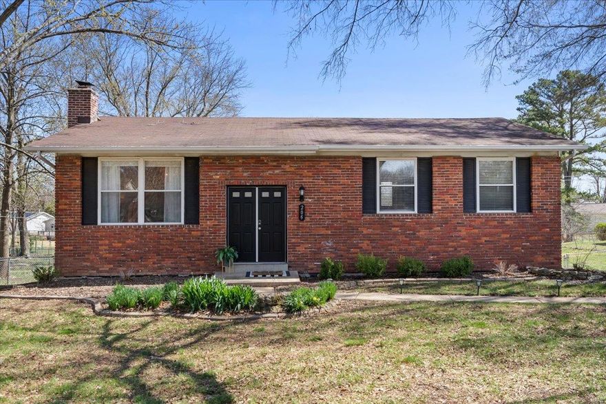 Discover a one-of-a-kind split-foyer home in Ellisville, where style meets functionality! This mainly brick beauty boasts rich, dark hardwood floors throughout, an inviting open-concept layout, and a fully updated kitchen with granite countertops, ample cabinetry, and generous counter space, perfect for entertaining. Step through the kitchen door to a huge deck overlooking the fully fenced backyard. The main level features three bedrooms, including a spacious primary suite with a stunning en-suite bath, plus an updated full bathroom in the hall. The lower level offers a cozy retreat with a gas fireplace and a versatile rec space for lounging, entertaining, or working out! A half bath near the garage adds extra convenience. Enjoy a two car tuck-under garage and a large rear carport for additional parking. This home is the perfect blend of comfort, charm and practicality. Located right off of Manchester Rd. close to shopping, restaurants, & more! You will not want to miss it!