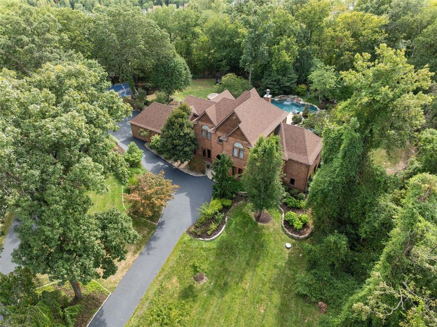 Nestled on over 3 acres, this impressive 1.5 story, 5 bedroom, 6 bath is located at the end of an idyllic street & offers a luxurious private retreat setting featuring a custom heated infinity pool with waterfall, hot tub, tiki hut, basketball court & expansive multi-level patio. A true showstopper, this magnificent estate offers a blend of luxury, comfort & convenience boasting over 5,599sq ft of living space in Lindbergh School district. The gourmet kitchen was featured in St. Louis Magazine outfitted with sub-zero refrigerator, new Bosch Gas cooktop, custom cabinetry, & center island opening into the hearth rm. This outstanding open floor plan offers a backdrop of windows, main level primary suite, private den, spacious living room w/fireplace & dining room. Huge Loft, 3 bedrooms & 2 bath are located on the 2nd fl. The professional movie theater by Custom Sound w/ stadium seating & soundproof paneling, is located in the finished walkout LL w/large rec area, bar, 5th bed & full bath