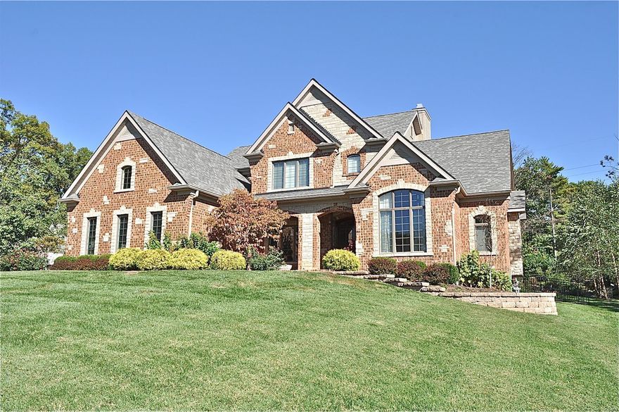 Showings begin at Open House, Sunday March 10, 1 - 3 p.m. Spectacular custom-built home on a private, elaborately landscaped 1.25 acre lot featuring tiered gardens, a waterfall, a dry creek, and a spacious yard for entertaining. This gorgeous residence has been meticulously maintained and tastefully improved. The first floor features light-filled spaces boasting coffered and vaulted ceilings, travertine and Brazilian cherry wood flooring, stone chimneys, bay windows, stainless Thermador appliances, and butler’s pantry. The walk-out finished lower level includes a 900-bottle capacity wine cellar, wet bar with refrigerator, recreation area with stone fireplace, movie screen and projector, plus a sleeping area and full bath. Other noteworthy features include built-in speaker system, security system, double wide concrete drive, three-car garage, and in-ground sprinkler system. All within moments of easy highway access to downtown, the west corridor, hospitals, the airport, and more. Additional Rooms: Mud Room